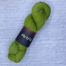 Load image into Gallery viewer, Green skein of yarn with a label on a textured white background