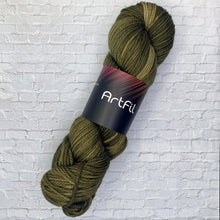 Load image into Gallery viewer, Green skein of yarn with 'Artful' label on a white brick background