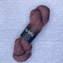Load image into Gallery viewer, Brown skein of yarn with a label on a textured white background