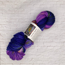 Load image into Gallery viewer, Several skeins of bulky weight yarn in various colors including yellow, purple, multicolor, and brown, with labels indicating the brand 'Songbird Yarn & Fibres'.