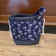 Load image into Gallery viewer, Navy blue bag with white skull pattern on a wooden floor