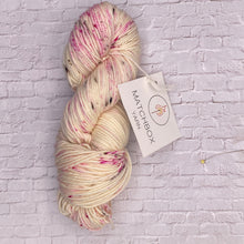 Load image into Gallery viewer, Spotted yarn skein with Matchbox Yarn label on a textured white background