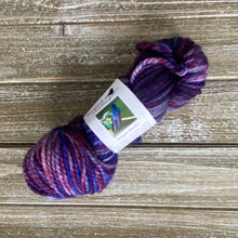 Load image into Gallery viewer, Several skeins of bulky weight yarn in various colors including yellow, purple, multicolor, and brown, with labels indicating the brand 'Songbird Yarn & Fibres'.