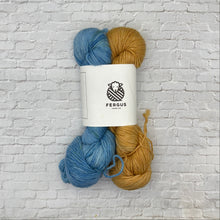 Load image into Gallery viewer, Two skeins of yarn, one yellow and one blue, with a Fergus label on a textured white background.
