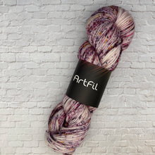 Load image into Gallery viewer, Multicolored skein of yarn with 'ArtFil' label on a light gray brick wall background
