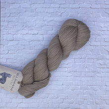 Load image into Gallery viewer, Brown skein of yarn with a &#39;lllimani&#39; label on a textured light blue background
