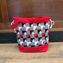 Load image into Gallery viewer, Checkered towel with red border on a wooden door
