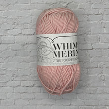 Load image into Gallery viewer, Ball of pink yarn with a label on a textured gray background
