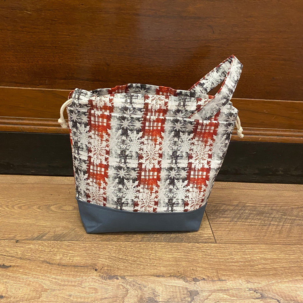 Patterned bag with blue base on wooden floor